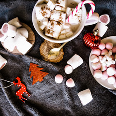 Good New Year spirit. Coffee with marshmallows and cinnamon. Candy canes. Pink mug. Cooking yourself. Home comfort. New Year. Christmas time. Winter mood.