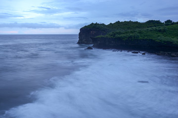 Fototapeta na wymiar blue ocean under cloudy sky in a bad weather long exposure photography