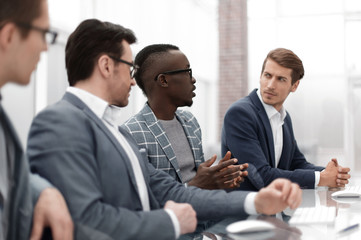 close up. multinational business team sitting at the Desk
