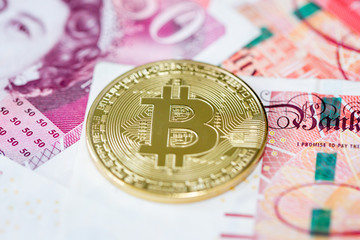Bitcoin and 50 pound banknotes
