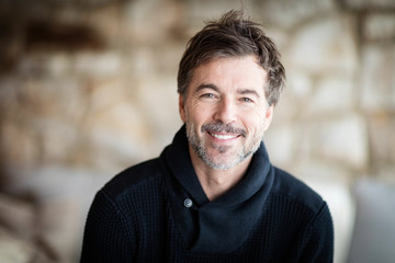 Fototapeta premium Mature Man Smiling And Relaxing At Home