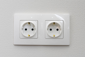 double electrical socket on white wallpaper