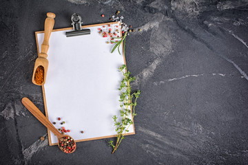 .Top view of mock-up composition with blank white sheet of paper with space and herbs