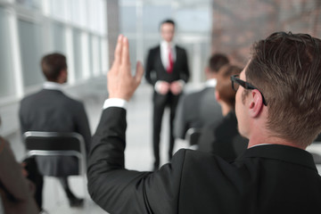 rear view. business seminar listener, asking the speaker