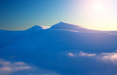 Magnificent dawn in the winter snowy mountains aerial view