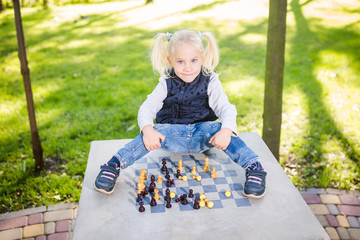 Funny Caucasian baby girl blonde does not want learn, does not want to school, want to play, laugh...