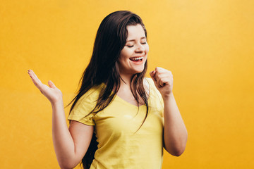 Woman singing isolated on color background. Happy woman singing with imaginary microphone