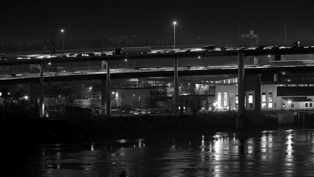 Black and white time lapse of traffic on Interstate 5. Portland, Oregon. No visible logos on vehicles. 