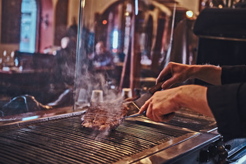 Cropped photo of a chef cooking delicious beef steak