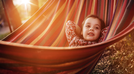 Cute little girl relaxing on a hammock