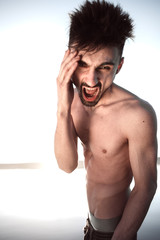 Fototapeta premium the guy with the naked torso screams