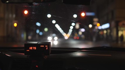 Interior view of cab meter and defocused lights. Taxi in Toronto, Canada.