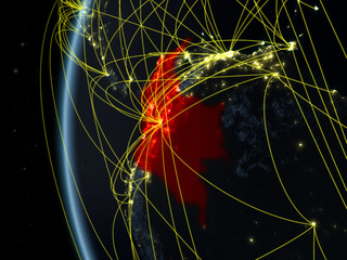 Colombia from space on model of Earth at night with international network. Concept of digital communication or travel.