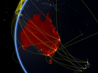 Australia from space on model of Earth at night with international network. Concept of digital communication or travel.