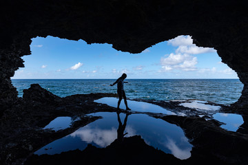 Valerie explores Animal Flower Cave at North Point, Barbados - obrazy, fototapety, plakaty