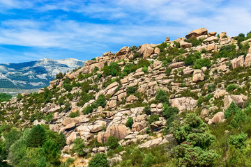 Fototapeta na wymiar View of a large mountain of rocks from a viewpoint of the Natural Park of La Pedriza. Photograph taken in Manzanares El Real, Madrid, Spain.