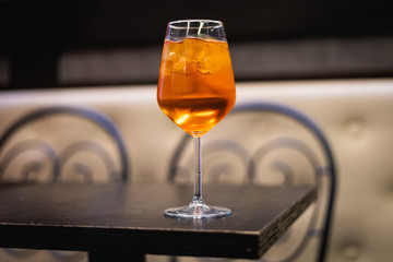 Spritz by night. Milan most famous cocktail glass with shallow depth of field.