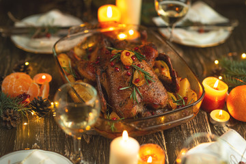 Roast duck. Thanksgiving table served with turkey, decorated with rosemary and pomegranate seeds and candles. Roast duck, table. Christmas dinner, Flat lay