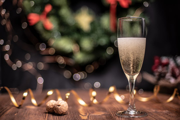 Smooth shady christmas and new year decoration background with round bokeh, golden ribbon and champagne and cork