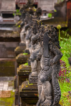 Balinese Stone Statuary at the Hindu Temple. Ancient stone carvings depicting the battle between good and evil meant to protect the temple and the worshipers.