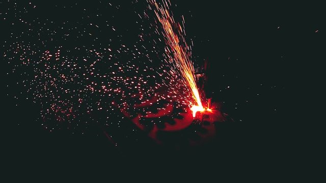 Plasma cutting machine is cutting flat sheet of metal by gas or laser in a super slow motion at the metal construction factory. A lot of red-hot sparks. Professional metalwork production