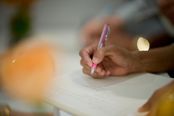 closeup hand writing paper, education concept
