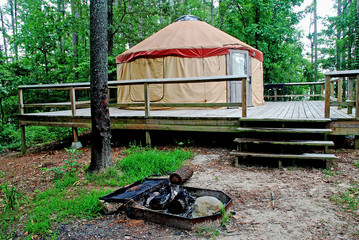 Yurt Camp Site built on a deck with in-ground fire ring in foreground.  DeGray Lake Resort State Park, Arkansas.  Taken shortly after rain shower.