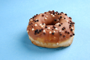Tradition Jewish holiday sweets, donut sufganioyt with sugar powder  on blue background with copy space