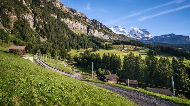 timelapse of railway to station Kleine Scheidegg with peak Jungfrau in the background in the evening