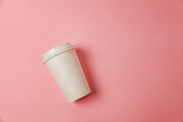 Simply flat lay design paper coffee cup on pink pastel colorful trendy background. Takeaway drink container. Good morning wake up awake concept. Template of drink mockup. Top view copy space