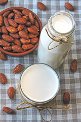 Fototapeta na wymiar Raw almonds and almond milk. Vegan drink.