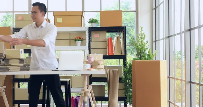 Young Asian man preparing boxes to delivery for customer, concept for online seller, lifestyle of modern businessman in startup business.