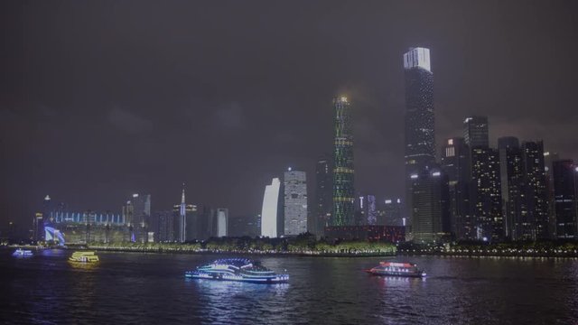 A view of Guangzhou CBD urban area with the tourist boats cruising along Pearl river in the night
