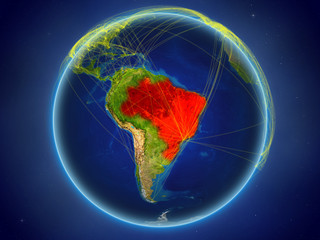 Brazil from space on planet Earth with digital network representing international communication, technology and travel.