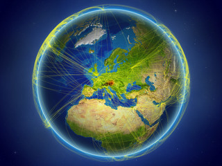 Austria from space on planet Earth with digital network representing international communication, technology and travel.