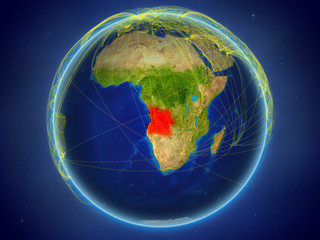 Angola from space on planet Earth with digital network representing international communication, technology and travel.