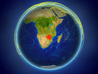 Zimbabwe from space on planet Earth with digital network representing international communication, technology and travel.