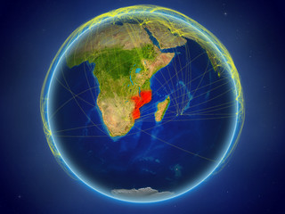Mozambique from space on planet Earth with digital network representing international communication, technology and travel.