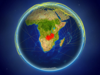 Zambia from space on planet Earth with digital network representing international communication, technology and travel.