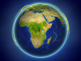 Rwanda from space on planet Earth with digital network representing international communication, technology and travel.