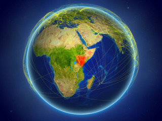 Kenya from space on planet Earth with digital network representing international communication, technology and travel.