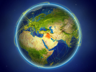 Iraq from space on planet Earth with digital network representing international communication, technology and travel.