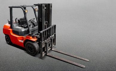 close up of red orange fork lift blades on an urban city street