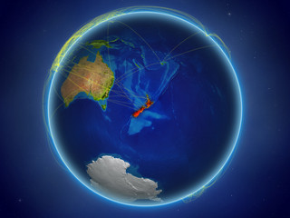 New Zealand from space on planet Earth with digital network representing international communication, technology and travel.