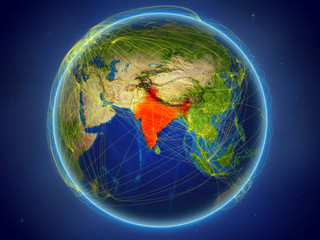 India from space on planet Earth with digital network representing international communication, technology and travel.