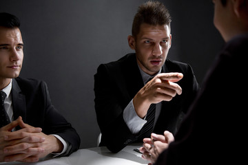 Detectives interview suspect in interrogation room