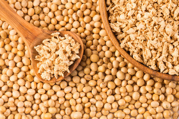 Crushed soybeans - Glycine max. Wooden bowl and spoon