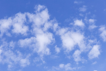 Blue sky background with white clouds. The vast blue sky and clouds sky on sunny day. White fluffy clouds in the blue sky.