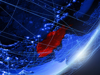 Afghanistan on green model of planet Earth with network at night. Concept of blue digital technology, communication and travel.