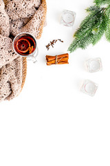 Hot beverage for warm winter evening. Mulled wine near fir branches, wool blanket, candles on white background top view space for text